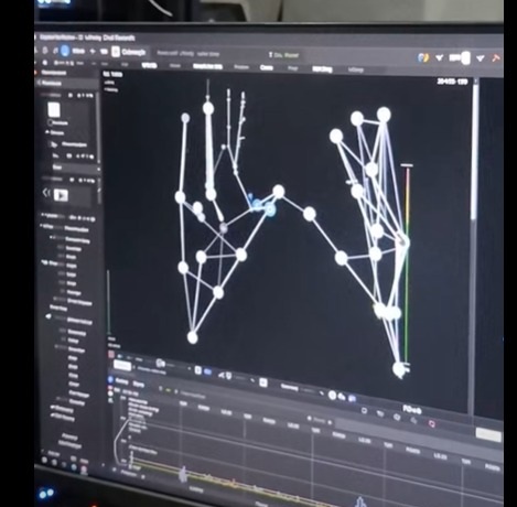 Computer display showing tracked hand joints and skeletal hand models